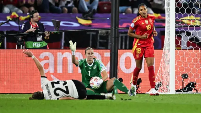 Germany's defender #23 Sophia Kleinherne (L) lies injured on the ground after a challenge with Spain's forward #18 Salma Paralluelo (R)
