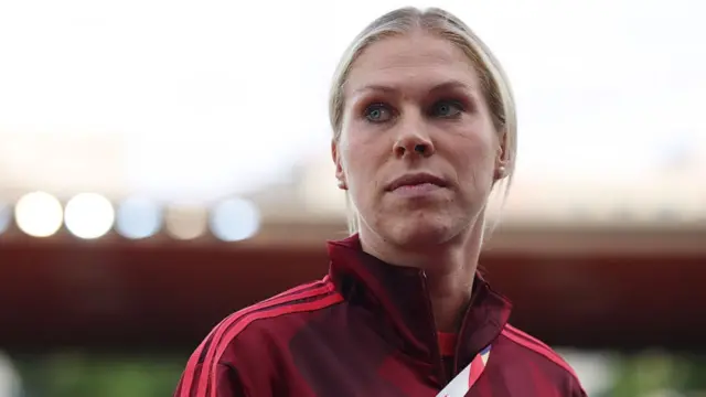 Rebecca Knaak of Germany inspects the pitch