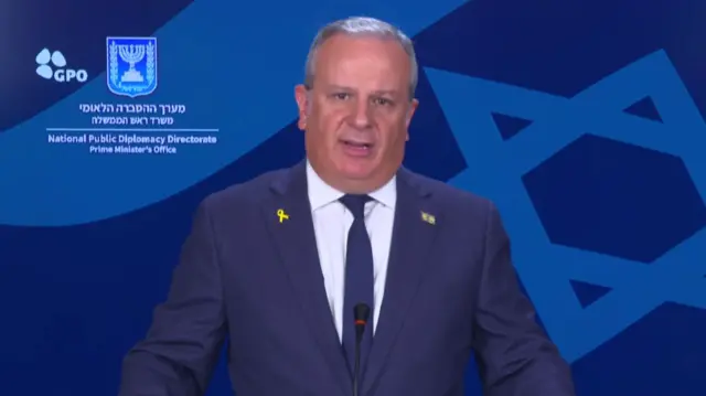 Israeli spokesman David Mencer speaks to press in a government briefing.