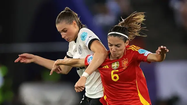 Jule Brand of Germany battles for possession with Aitana Bonmati of Spain