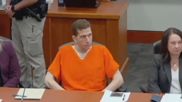Kohberger sitting at a desk looking to his side