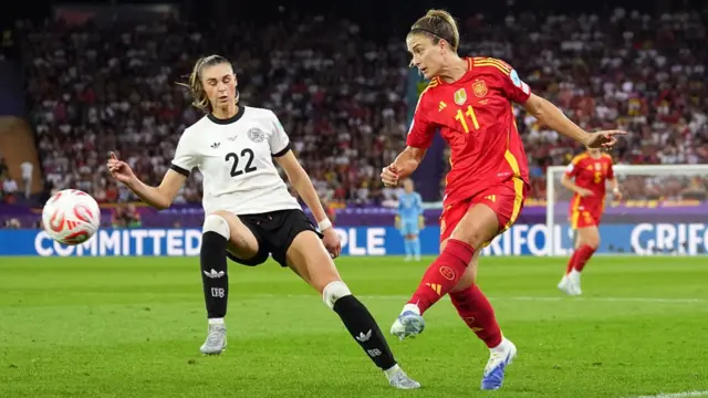 Alexia Putellas of Spain passes the ball whilst under pressure from Jule Brand of Germany