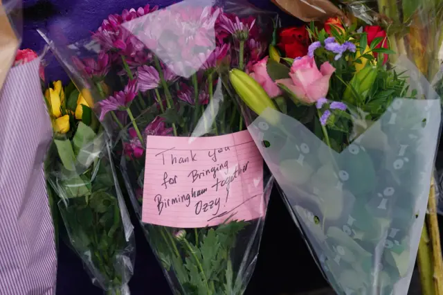 Flowers left at mural