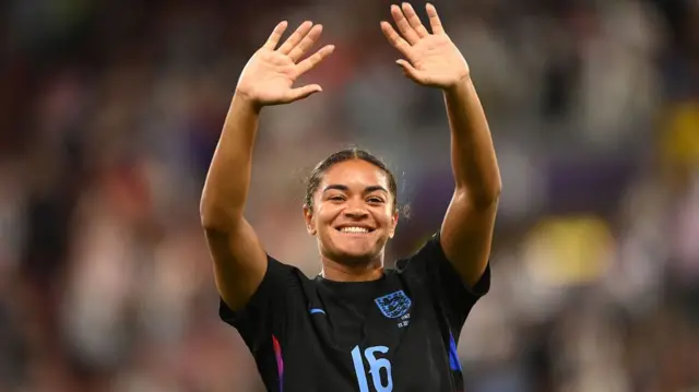 Jess Carter waves to fans