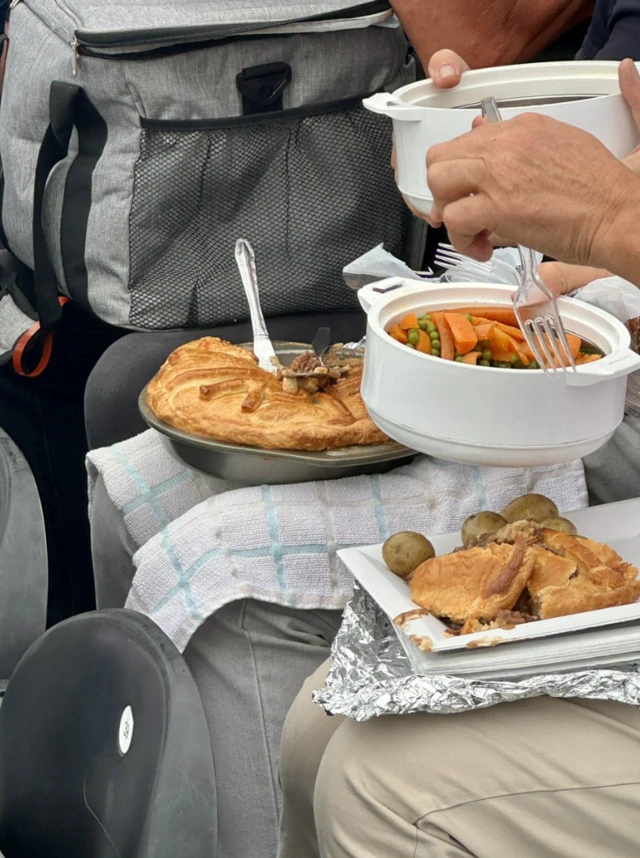 A steak pie, vegetables and gravy.