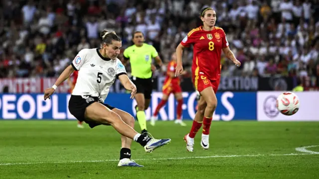 Germany's forward #05 Carlotta Wamser (L) shoots towards goal