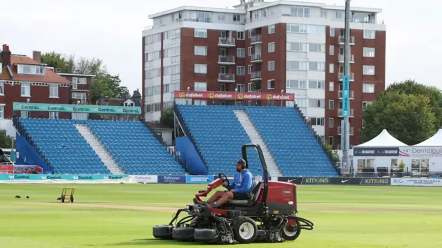 Ground staff working on the pitch at Hove ahead of day two between Sussex and Essex