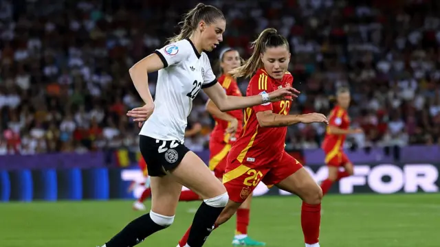 ule Brand of Germany runs with the ball whilst under pressure from Claudia Pina of Spain