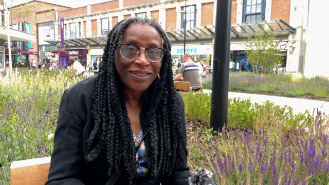 Naomi sat in the town centre