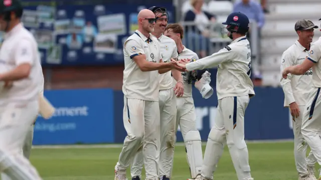Derbyshire celebrate taking a wicket against Leicestershire