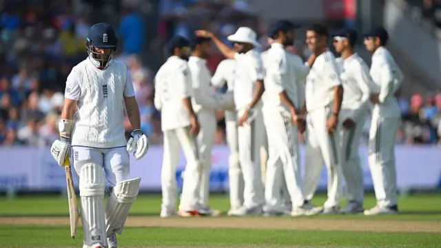 Ben Duckett walking off with the India team celebrating behind