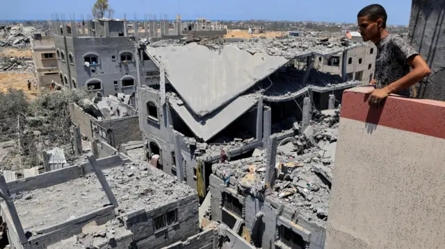 A Palestinian man inspects the damage on Wednesday after an Israeli military operation, in Deir al-Balah, central Gaza Strip