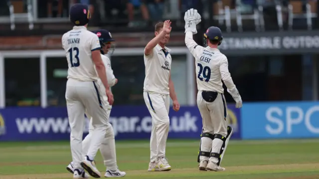 Luis Reece is congratulated on taking a wicket for Derbyshire