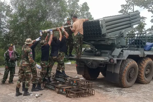 A group of Cambodian soldiers reload a truck-mounted BM-21 multiple rocket launcher