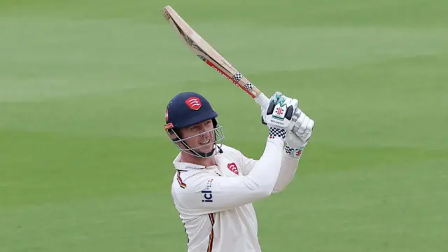 Simon Harmer hits a six for Essex at Sussex