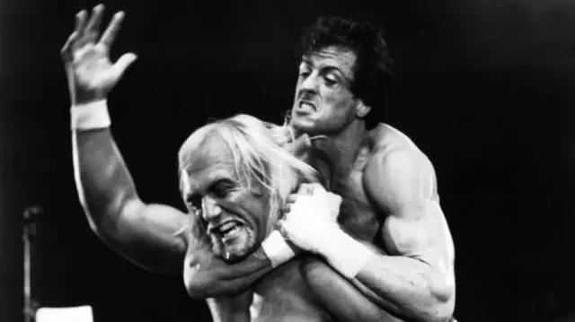 A still from Rock III where Sylvester Stallone has Hulk Hogan in a headlock