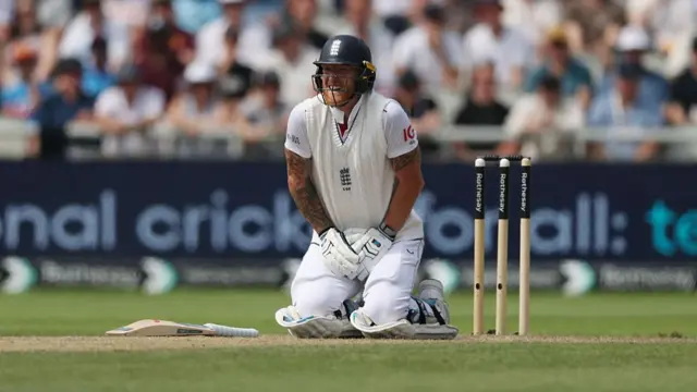 Ben Stokes on his knees after being hit by a ball.