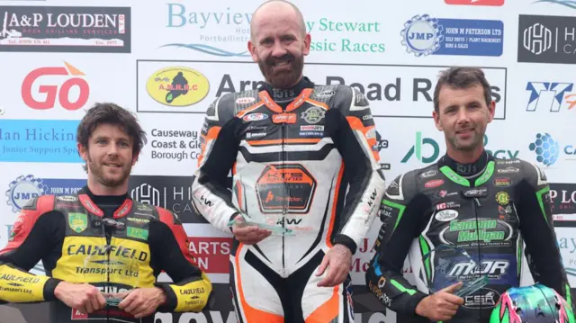 Man-of-the-meeting Jamie Coward flanked by Mike Browne and Michael Sweeney on the podium in 2024