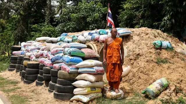 A monk is seen near a bomb shelter amid the escalation of the Thailand-Cambodia dispute in Thailand's Surin Province