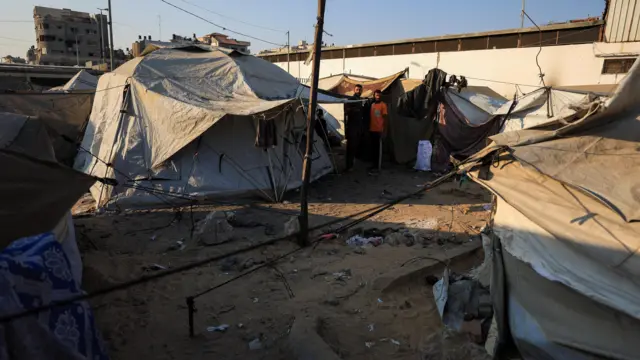 Gazans outside a tent in Gaza City