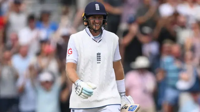 Joe Root smiles after hitting a century at Old Trafford.