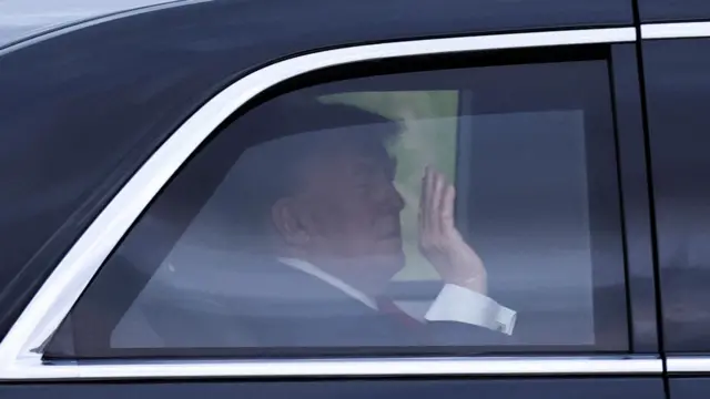 U.S. President Donald Trump waves from inside a vehicle on his way to Turnberry, in Minishant, Scotland, Britain, July 25, 2025.