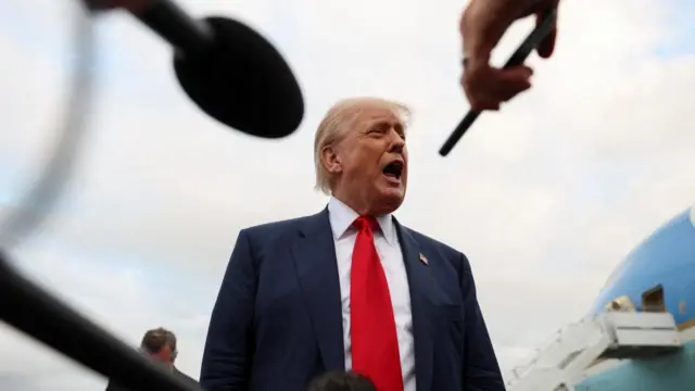 U.S. President Donald Trump speaks to members of the media on his arrival at Glasgow Prestwick Airport,