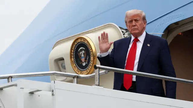 U.S. President Donald Trump waves as he disembarks from Air Force One at Glasgow Prestwick Airport, in Prestwick, Scotland, Britain, July 25, 2025.
