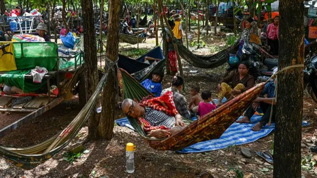 People who evacuated rest on the grounds of a pagoda in Cambodia's Oddar Meanchey province