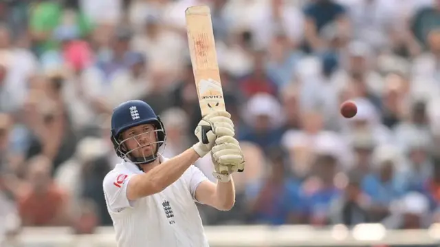 Liam Dawson holds his marked bat