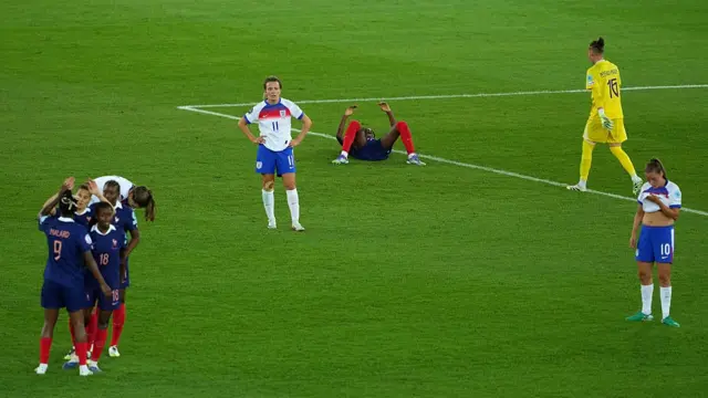 Lauren Hemp and Ella Toone of England look dejected, as players of France celebrate victory