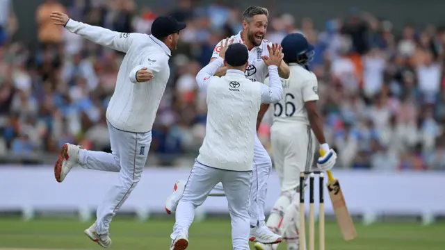 England team congratulating Chris Woakes