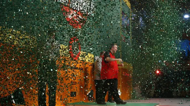 Phil Taylor celebrates after beating Wayne Mardle