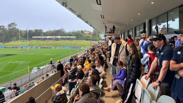 The crowd wait as players have been taken off at the Ballymore Stadium