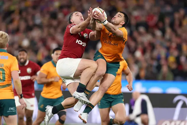 Australia's Tom Wright (R) and British and Irish Lions' James Lowe compete for a high-ball