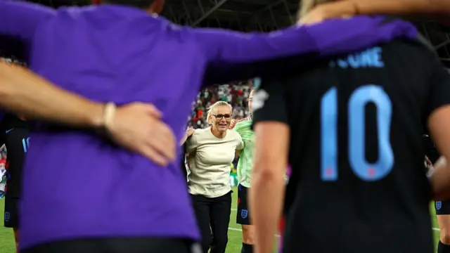 Sarina Wiegman, Head Coach of England, leads a team talk as the players form a huddle following the team's victory and subsequent progression into the final following the UEFA Women's EURO 2025 Semi-Final match between England and Italy at Stade de Geneve