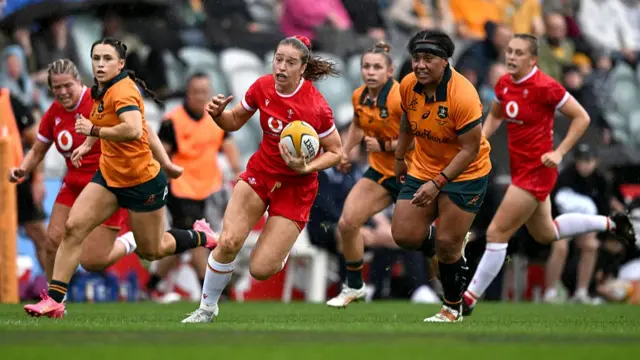 Lisa Neumann of Wales runs the ball
