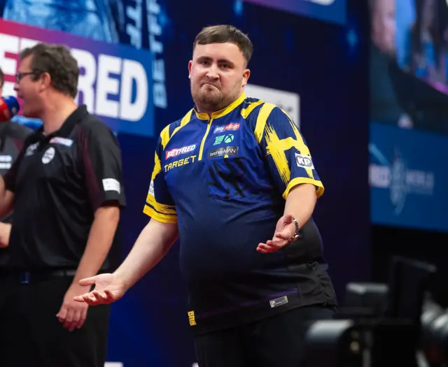 Luke Littler celebrates after hitting a nine darter