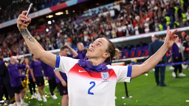 Lucy Bronze of England takes a selfie as she celebrates