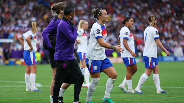 Lucy Bronze of England temporarily leaves the pitch injured