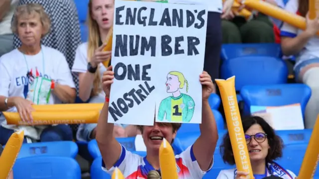 England fan with a sign inside the stadium before the match