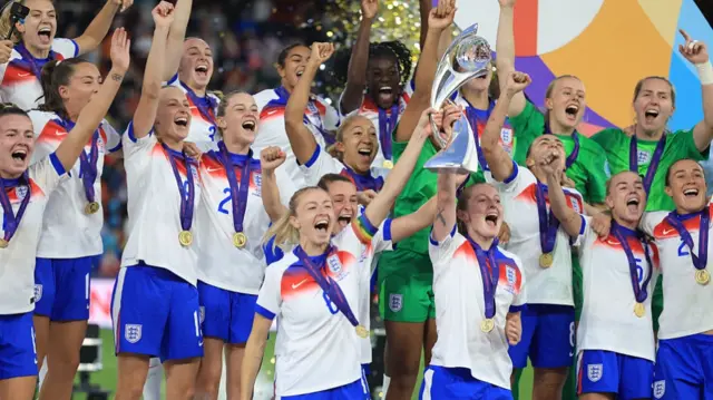 England players lift the trophy