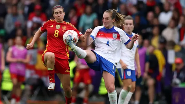 Keira Walsh of England clears the ball whilst under pressure from Mariona Caldentey of Spain