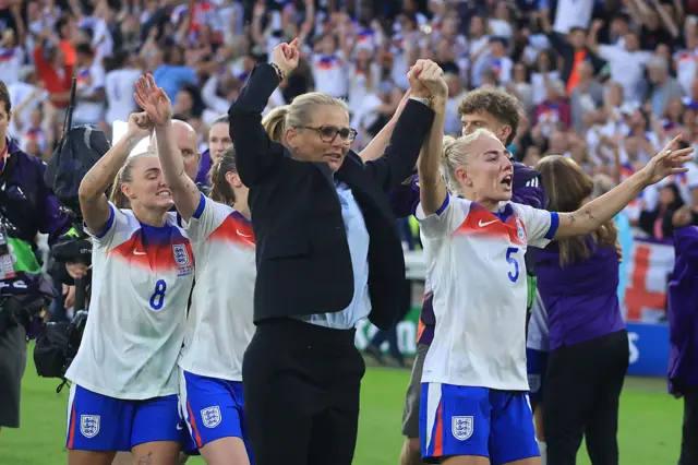 Sarina Wiegman celebrates with Alex Greenwood and England players