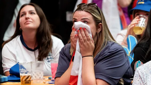 An England fan reacts as they watch a live broadcast of the Women's Euro final football match between England and Spain, at Boxpark Wembley