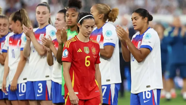 Aitana Bonmati of Spain looks dejected as she walks through a guard of honour formed by players of England after England defeat Spain in a penalty shootout