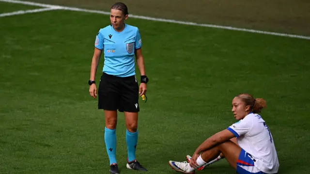 French referee Stéphanie Frappart (L) stands by England's forward #07 Lauren James prior to James leaving the pitch following injury