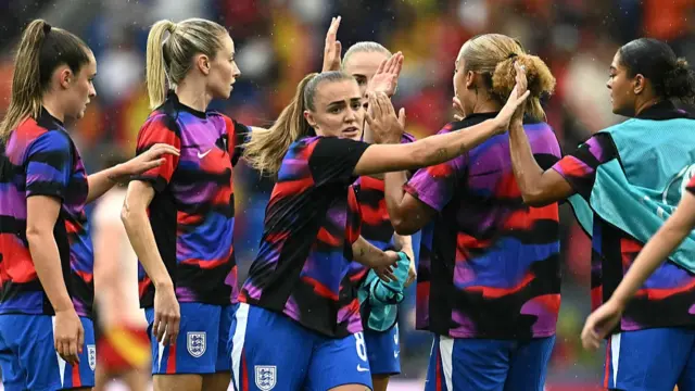England's midfielder #08 Georgia Stanway gives a high-five as she warms up ahead of the UEFA Women's Euro 2025 final football match between England and Spain at the St. Jakob-Park