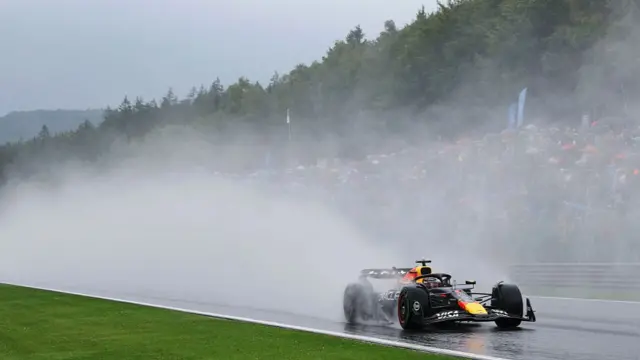 Max Verstappen with lots of spray coming off his car in the wet at Spa.