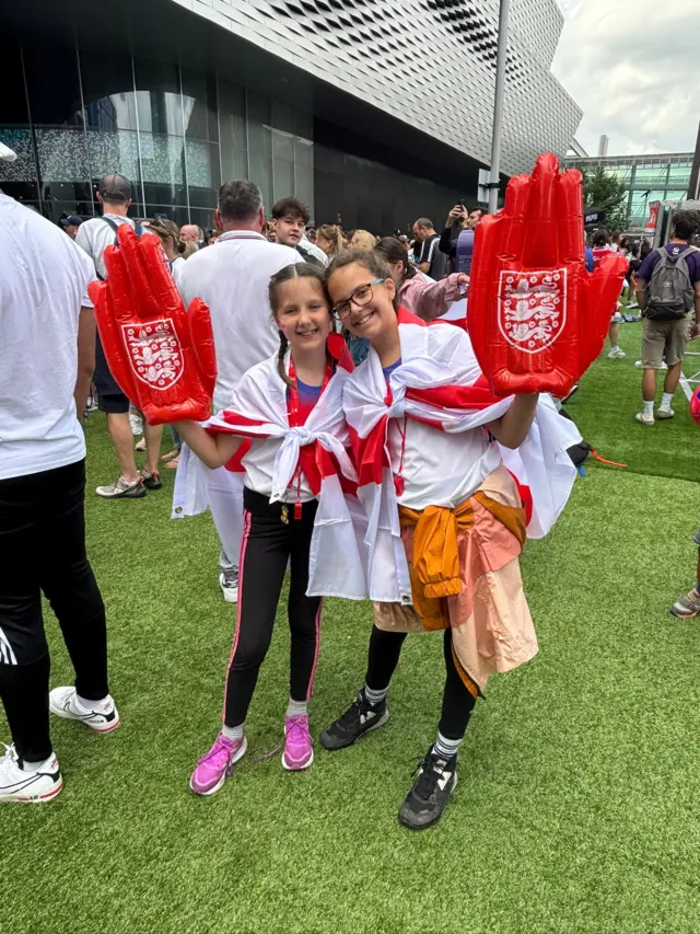 Maisie and Rosie pose in Basel with England merchandise
